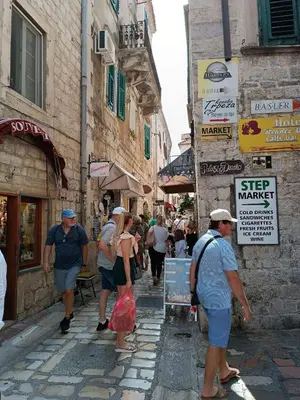 a group of people walking down a narrow street at Guesthouse BiT Accommodation in Kotor