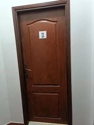 a wooden door with the number on it at Guesthouse BiT Accommodation in Kotor