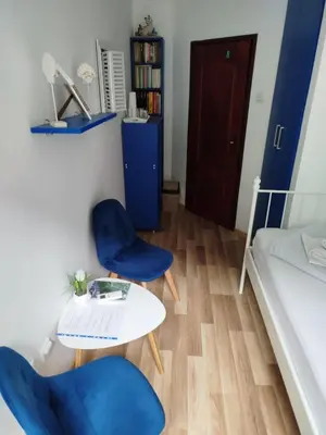 a room with two chairs and a table and a bed at Guesthouse BiT Accommodation in Kotor