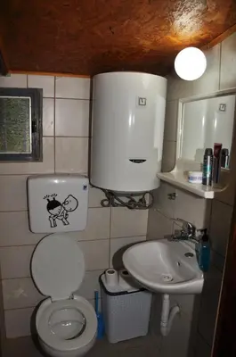 a small bathroom with a toilet and a sink at Skadar Lake House Virpazar in Virpazar