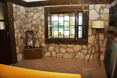 a room with a stone wall and a window at Skadar Lake House Virpazar in Virpazar