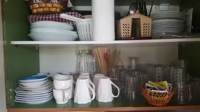 a cupboard filled with plates and bowls and other dishes at Skadar Lake House Virpazar in Virpazar