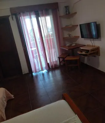 a living room with a couch and a television and a table at Apartment Klara in Bar