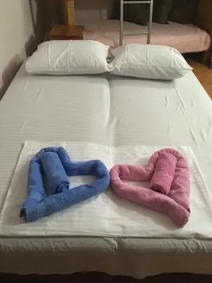 two towels are sitting on a bed at Apartment Klara in Bar