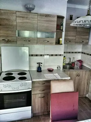 a kitchen with a stove and a white stove top oven at Apartment Podkosljun in Budva