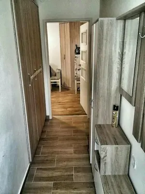 a hallway with a tile floor in a room at Apartment Podkosljun in Budva