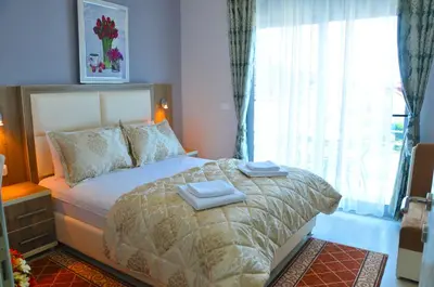 a bedroom with a bed with two towels on it at Ambassador & Ambassador Lux Apartments in Ulcinj