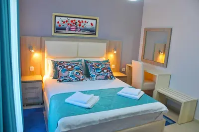 a bedroom with a bed with two towels on it at Ambassador & Ambassador Lux Apartments in Ulcinj