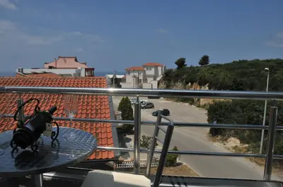 a bag sitting on a glass table on a balcony at Ambassador & Ambassador Lux Apartments in Ulcinj