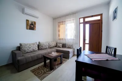 a living room with a couch and a table at Kollari Apartments in Ulcinj