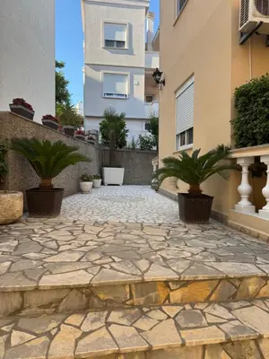 a stone patio in front of a building at Apartments Onyx in Ulcinj