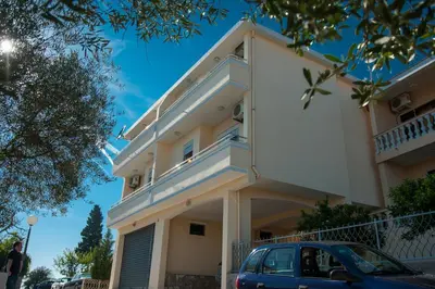 a building with a car parked in front of it at Apartments Onyx in Ulcinj