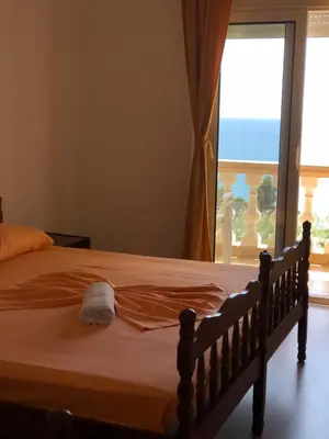 a bedroom with a bed with a view of the ocean at Apartments Onyx in Ulcinj