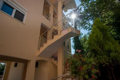 a person standing on a balcony of a building at Apartments Onyx in Ulcinj