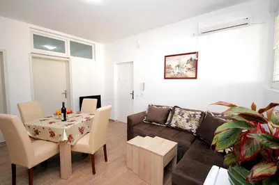 a living room with a couch and a table at Apartments Centar Sutomore in Sutomore
