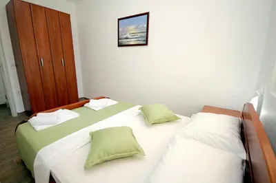 a bedroom with two twin beds and a cabinet at Apartments Centar Sutomore in Sutomore