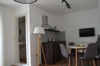 a kitchen and dining room with a table and chairs at Casablanca Apartments in Budva