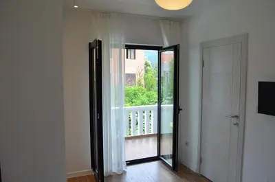 a room with a door leading to a balcony at Casablanca Apartments in Budva