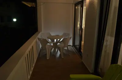 a small table and chairs on a balcony at night at Casablanca Apartments in Budva