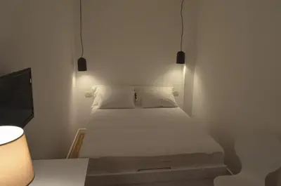 a small bedroom with a bed and a television at Casablanca Apartments in Budva