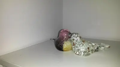 a glass bird statue sitting on top of a table at Apartmani Drašković in Petrovac na Moru