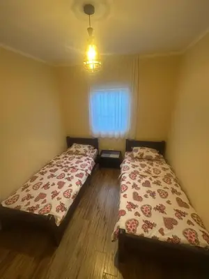 a bedroom with two beds and a window at Home Šćekić in Budva