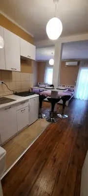 an empty kitchen with a table in a room at Home Šćekić in Budva