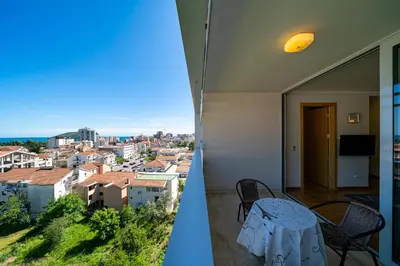 a balcony with a table and a view of a city at Apt 