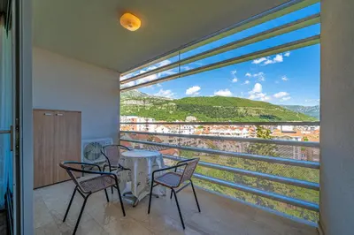 a balcony with a table and chairs and a view at Apt 