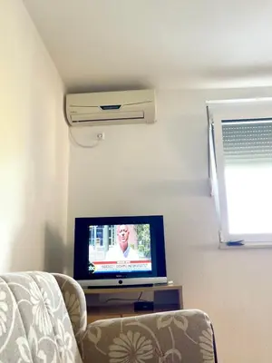 a living room with a tv and a couch at Apartments Vali in Ulcinj