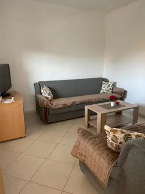 a living room with two couches and a tv at Apartments Vali in Ulcinj