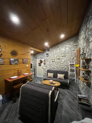 a living room with a couch and a table at Apartman Sofranac in Rijeka Crnojevića