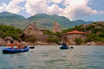 a group of people riding on tubes in the water at Apartman Sofranac in Rijeka Crnojevića