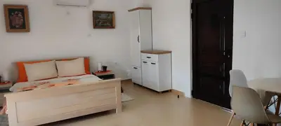 a bedroom with a bed and a table and chairs at Village house - Novak Rijecani in Rijeka Crnojevića