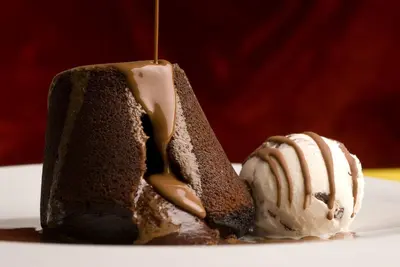 a piece of chocolate cake with ice cream on a plate at Boutique Hotel Astoria in Kotor