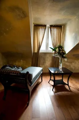 a room with a bench and a table and a window at Boutique Hotel Astoria in Kotor
