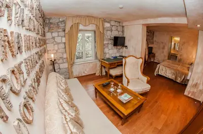 a living room with a couch and a table at Boutique Hotel Astoria in Kotor