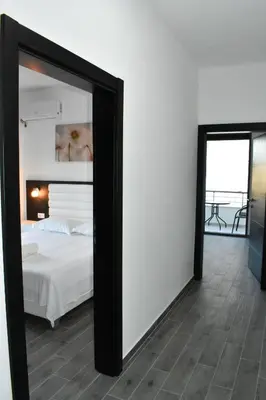 a mirror in a bedroom with a bed and a balcony at Flo Apartments in Ulcinj