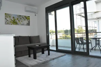 a living room with a couch and a table at Flo Apartments in Ulcinj