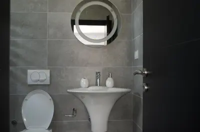 a bathroom with a white sink and a mirror at Flo Apartments in Ulcinj