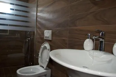 a bathroom with a sink and a toilet at Flo Apartments in Ulcinj