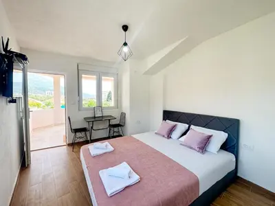 a bedroom with a bed with two towels on it at Jasmin apartmani in Bar