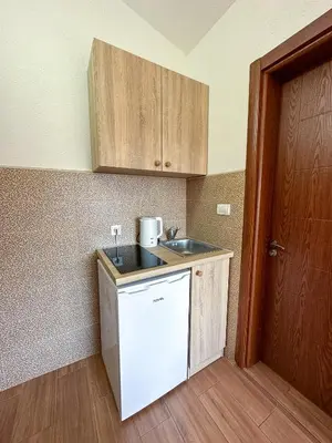 a small kitchen with a sink and a counter at Jasmin apartmani in Bar