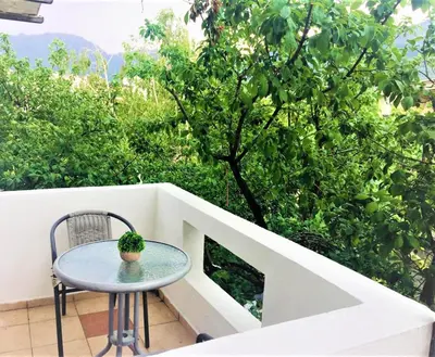 a small table and a chair on a balcony at Guesthouse Berlin in Bar