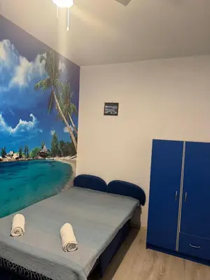 a bedroom with a bed with a painting on the wall at Studio apartmani DENNUS in Bar