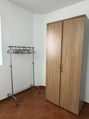 a room with a closet and a wooden cabinet at Studio apartmani DENNUS in Bar