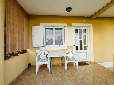 a dining room with a table and two chairs at Studio apartmani DENNUS in Bar