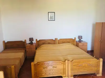 a bedroom with two wooden beds and two dressers at Studio apartmani DENNUS in Bar