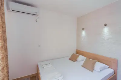 a small room with a bed and a window at Apartmani 