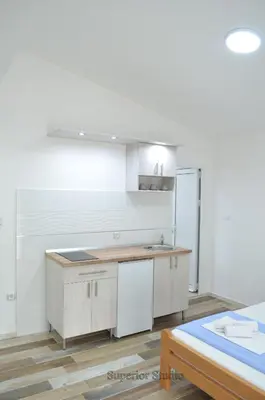 a kitchen with a sink and a counter top at Apartmani 